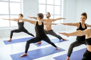 Group of people practising yoga indoors